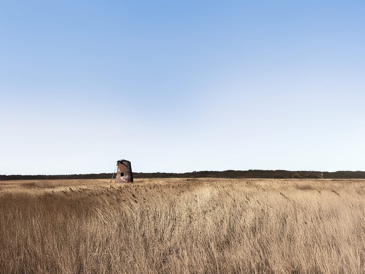 old windmill in field in walberswick suffolk
